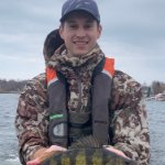 Tyler Hoyt displays a large yellow perch during fieldwork. on April 5, 2024